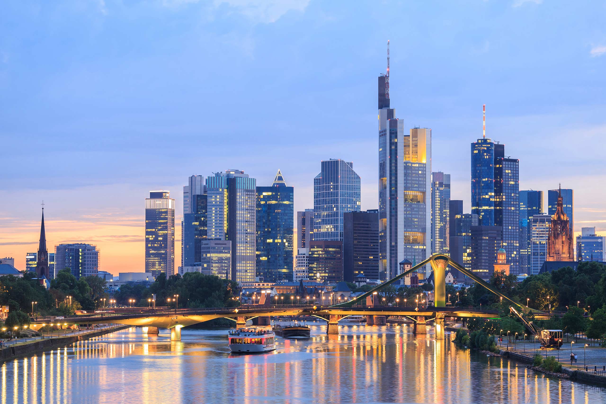 Frankfurt skyline at sunset with modern skyscrapers reflected in the River Main